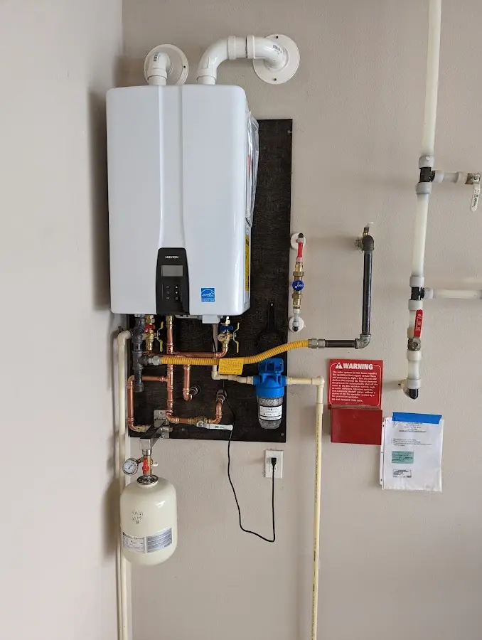 Professional plumber installing copper piping in a Sheridan home